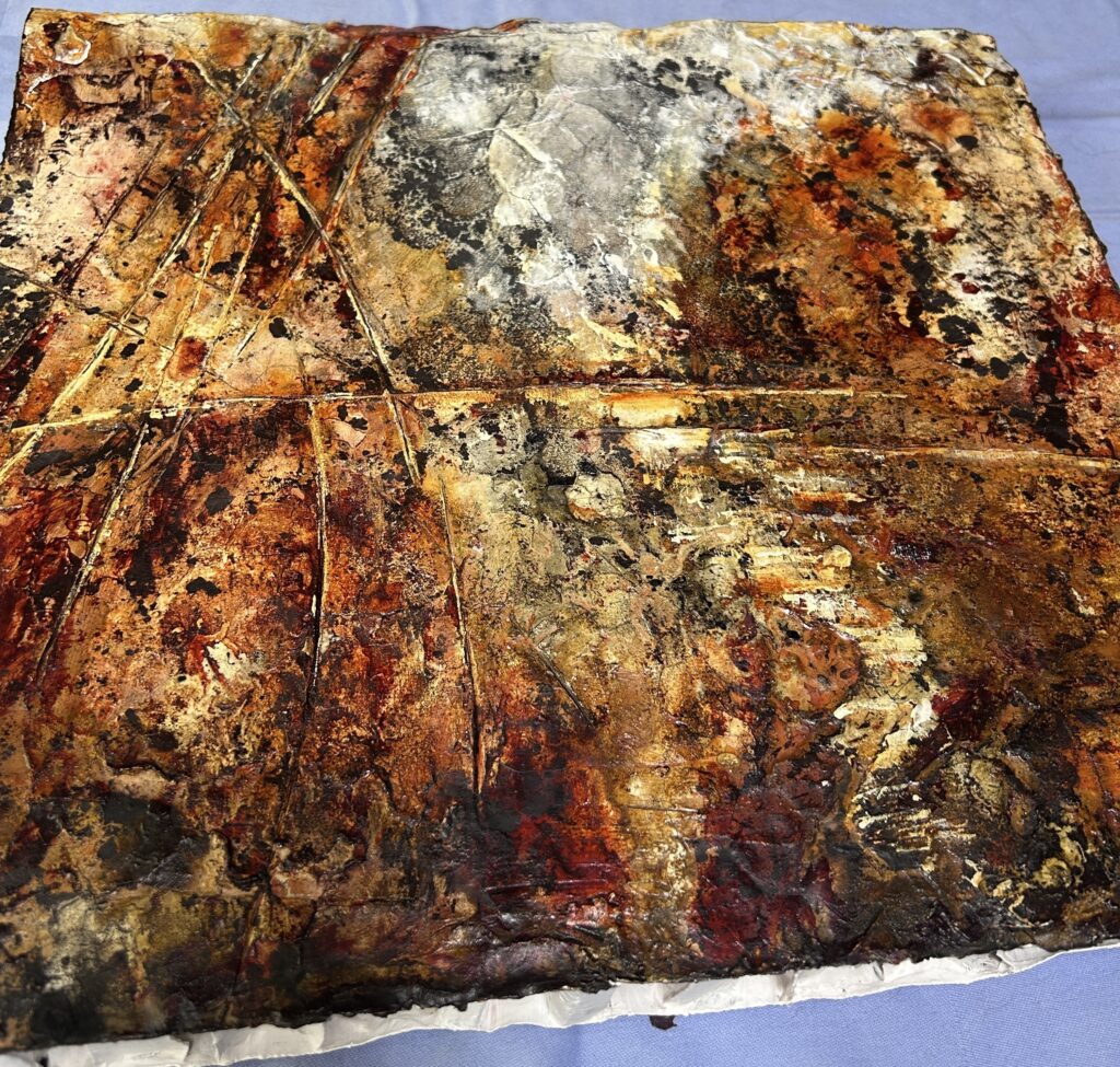 Angled view of the matter painting "From Waste to Presence" on upcycled cardboard, showing layered lime textures and raw edges